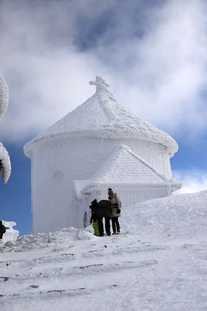KARPACZ, POLAND - MARCH 08, 2020: St. Lawrence's Chapel in the Winter. A Roman Catholic chapel located on the peak of Sniezka mountain (1602 m. above sea level), Giant Mountains, Poland, Europe.のeditorial素材