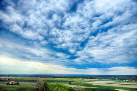 WROCLAW, POLAND - MAY 28, 2020: Beautiful, green fields and cloudy sky in the end of may. View from the Trzebnica hills, near Wroclaw, Poland, Europe.のeditorial素材