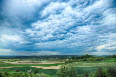 Beautiful, green fields and cloudy sky in the end of may. View from the Trzebnica hills, near...