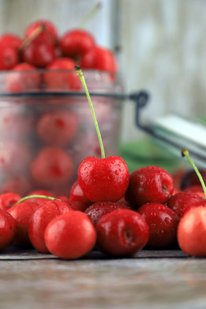 Fresh, healthy, real cherries from organic farming, ecological harvest on wood background.