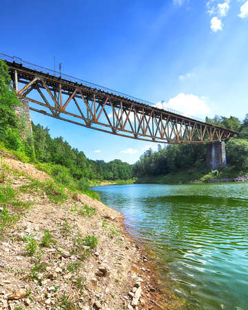 PILCHOWICE, POLAND - AUGUST 12, 2020: Railway bridge over Pilchowice Lake, which was supposed to be blown up for the filming of "Mission Impossible 7", Pilchowice, Poland, Europe.のeditorial素材