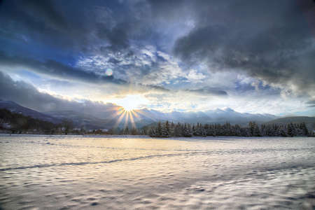Beautiful winter landscape from the vicinity of Karpacz during the beginning of the sunset. View towards Sniezka and Mala Kopa. Giant Mountains, Poland, Europe.の写真素材