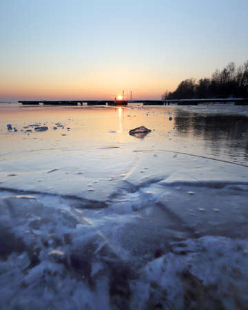 A beautiful sunset over the frozen Mietkow Lake, during extremely low temperatures in February. Mietkow near Wroclaw, Poland, Europe.の写真素材