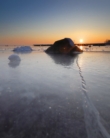 A beautiful sunset over the frozen Mietkow Lake, during extremely low temperatures in February. Mietkow near Wroclaw, Poland, Europe.の写真素材