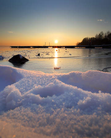 A beautiful sunset over the frozen Mietkow Lake, during extremely low temperatures in February. Mietkow near Wroclaw, Poland, Europe.の写真素材