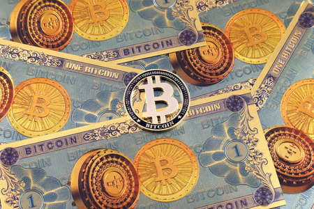A physical version of Bitcoin in the form of coins and banknotes. A conceptual image for investors in the fast-growing cryptocurrency and blockchain technology market.の写真素材