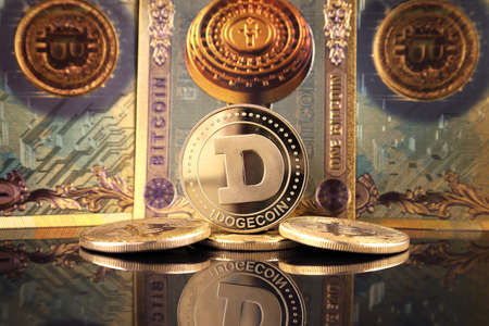 A physical version of Dogecoin (Cryptocurrency) in the form of coin and Bitcoin banknotes. A conceptual image for investors in the fast-growing cryptocurrency and blockchain technology market.の写真素材