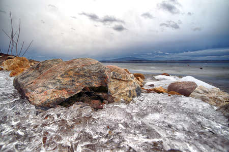 An ice-covered beach by the Mietkowski Lagoon, with the Sleza Mountain in the background. Mietkow near Wroclaw, Poland, Europe.の写真素材