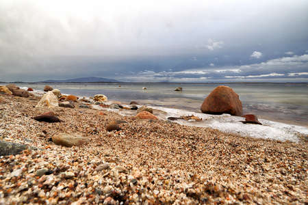 An ice-covered beach by the Mietkowski Lagoon, with the Sleza Mountain in the background. Mietkow near Wroclaw, Poland, Europe.の写真素材