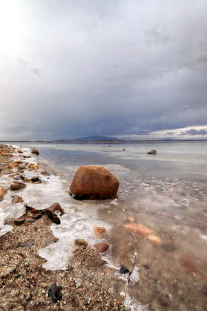 An ice-covered beach by the Mietkowski Lagoon, with the Sleza Mountain in the background. Mietkow near Wroclaw, Poland, Europe.の写真素材