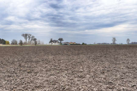 Preparing field for planting. Plowed soil in spring time.の写真素材