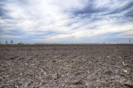 Preparing field for planting. Plowed soil in spring time.の写真素材
