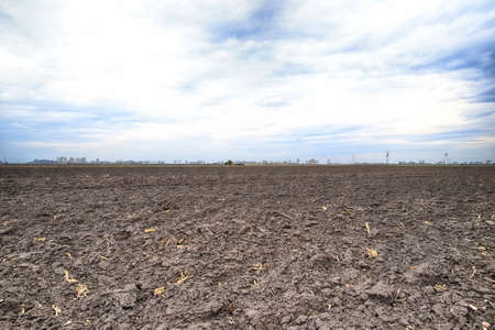 Preparing field for planting. Plowed soil in spring time.の写真素材
