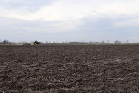 Preparing field for planting. Plowed soil in spring time.の写真素材