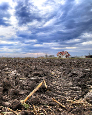Preparing field for planting. Plowed soil in spring time.の写真素材