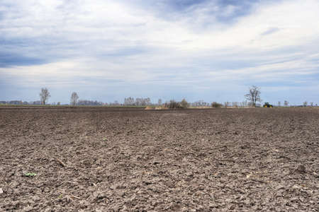 Preparing field for planting. Plowed soil in spring time.の写真素材
