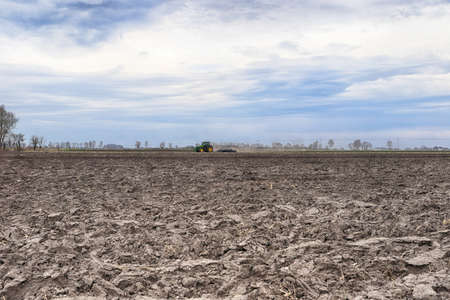 Preparing field for planting. Plowed soil in spring time.の写真素材