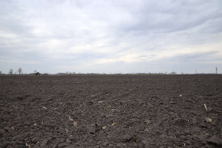 Preparing field for planting. Plowed soil in spring time.の写真素材