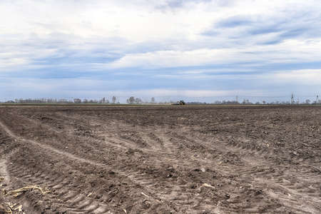 Preparing field for planting. Plowed soil in spring time.の写真素材