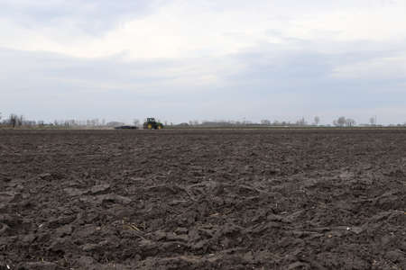 Preparing field for planting. Plowed soil in spring time.の写真素材