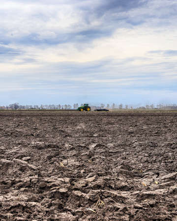 Preparing field for planting. Plowed soil in spring time.の写真素材