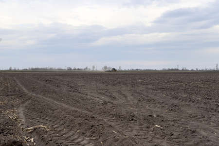 Preparing field for planting. Plowed soil in spring time.の写真素材