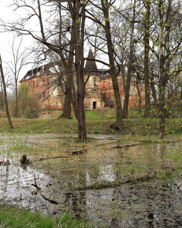 WROCLAW, POLAND - APRIL 11, 2021: Palace in Komorowice near Wroclaw, Poland. Beautiful palace park at the beginning of spring.のeditorial素材