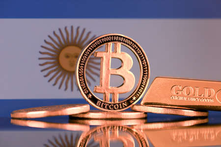 Physical version of Bitcoin, gold bar and Argentina Flag.の写真素材