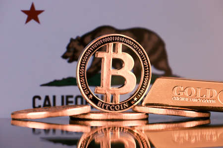 Physical version of Bitcoin, gold bar and California State Flag.の写真素材