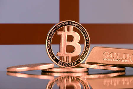 Physical version of Bitcoin, gold bar and England Flag.の写真素材