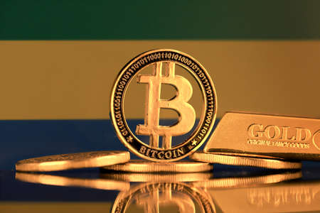Physical version of Bitcoin, gold bar and Gabon Flag.の写真素材