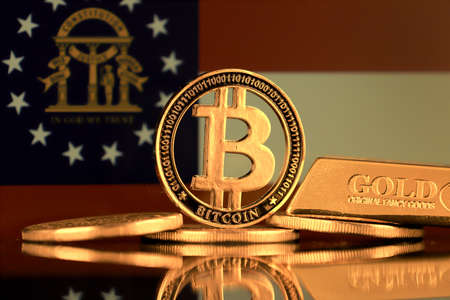 Physical version of Bitcoin, gold bar and Georgia State Flag.の写真素材