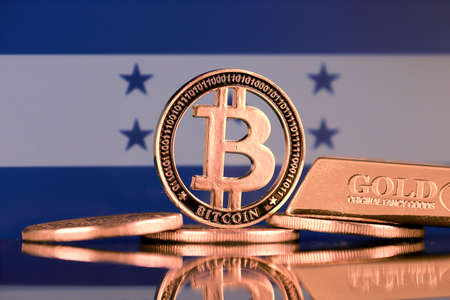 Physical version of Bitcoin, gold bar and Honduras Flag.の写真素材
