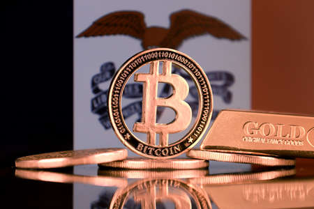 Physical version of Bitcoin, gold bar and Iowa State Flag.の写真素材