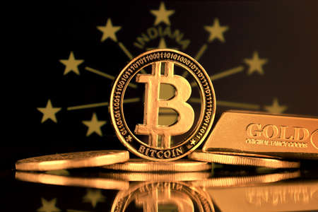 Physical version of Bitcoin, gold bar and Indiana State Flag.の写真素材