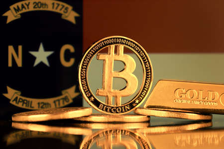 Physical version of Bitcoin, gold bar and North Carolina Flag.の写真素材