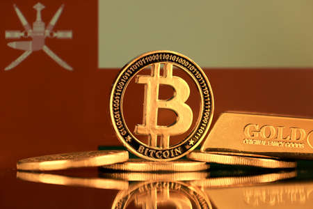 Physical version of Bitcoin, gold bar and Oman Flag.の写真素材