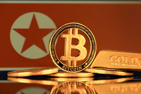 Physical version of Bitcoin, gold bar and North Korea Flag.の写真素材