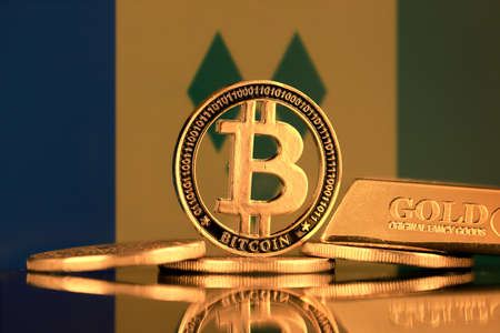 Physical version of Bitcoin, gold bar and Saint Vincent and The Grenadines Flag.の写真素材