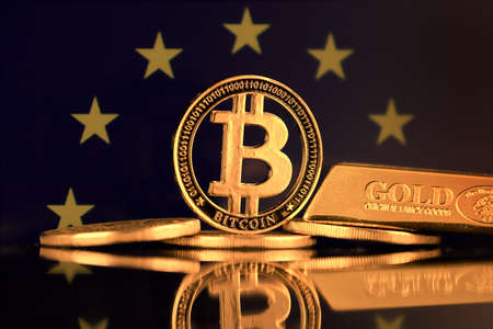 Physical version of Bitcoin, gold bar and European Union Flag.の写真素材