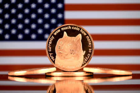A physical version of Dogecoin (Cryptocurrency) and United States Flag.の写真素材