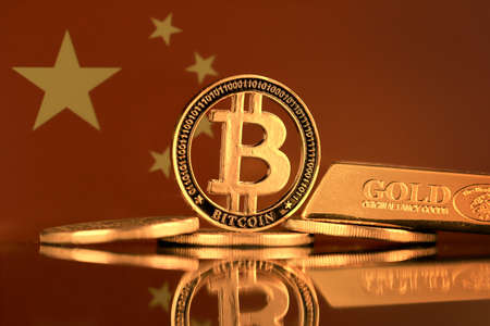 Physical version of Bitcoin, gold bar and China Flag.の写真素材