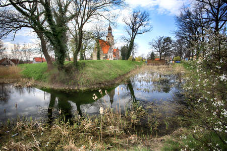 WROCLAW, POLAND - APRIL 21, 2021: Roman Catholic Church of st. Trinity (17th century, 1597-1602) situated on a small island in the river in Zorawina near Wroclaw, Poland.のeditorial素材