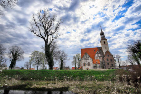 WROCLAW, POLAND - APRIL 21, 2021: Roman Catholic Church of st. Trinity (17th century, 1597-1602) situated on a small island in the river in Zorawina near Wroclaw, Poland.のeditorial素材