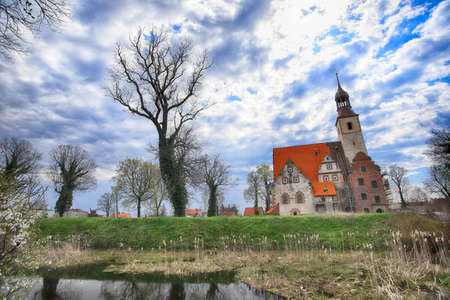 WROCLAW, POLAND - APRIL 21, 2021: Roman Catholic Church of st. Trinity (17th century, 1597-1602) situated on a small island in the river in Zorawina near Wroclaw, Poland.のeditorial素材
