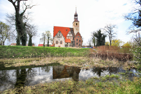 WROCLAW, POLAND - APRIL 21, 2021: Roman Catholic Church of st. Trinity (17th century, 1597-1602) situated on a small island in the river in Zorawina near Wroclaw, Poland.のeditorial素材