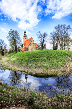 WROCLAW, POLAND - APRIL 21, 2021: Roman Catholic Church of st. Trinity (17th century, 1597-1602) situated on a small island in the river in Zorawina near Wroclaw, Poland.のeditorial素材