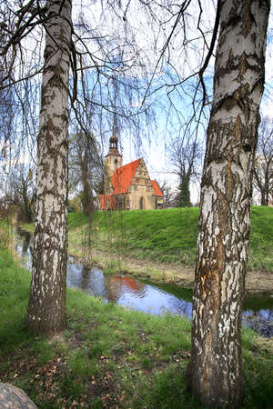 WROCLAW, POLAND - APRIL 21, 2021: Roman Catholic Church of st. Trinity (17th century, 1597-1602) situated on a small island in the river in Zorawina near Wroclaw, Poland.のeditorial素材