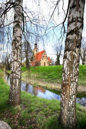 WROCLAW, POLAND - APRIL 21, 2021: Roman Catholic Church of st. Trinity (17th century, 1597-1602) situated on a small island in the river in Zorawina near Wroclaw, Poland.のeditorial素材
