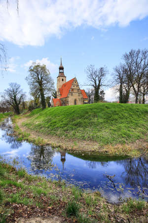 WROCLAW, POLAND - APRIL 21, 2021: Roman Catholic Church of st. Trinity (17th century, 1597-1602) situated on a small island in the river in Zorawina near Wroclaw, Poland.のeditorial素材
